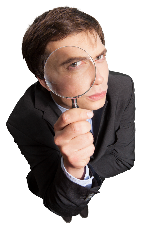 Businessman Standing and Looking through a Magnifying Glass - Isolated